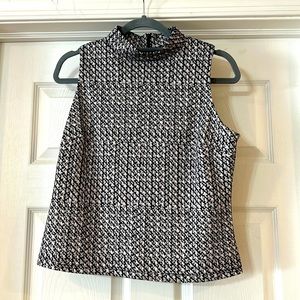 Turtleneck sleeveless blouse.